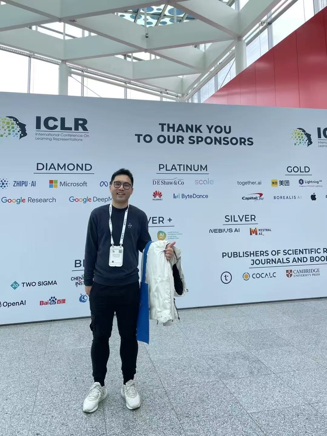 In front of the ICLR 2024 sponsor wall