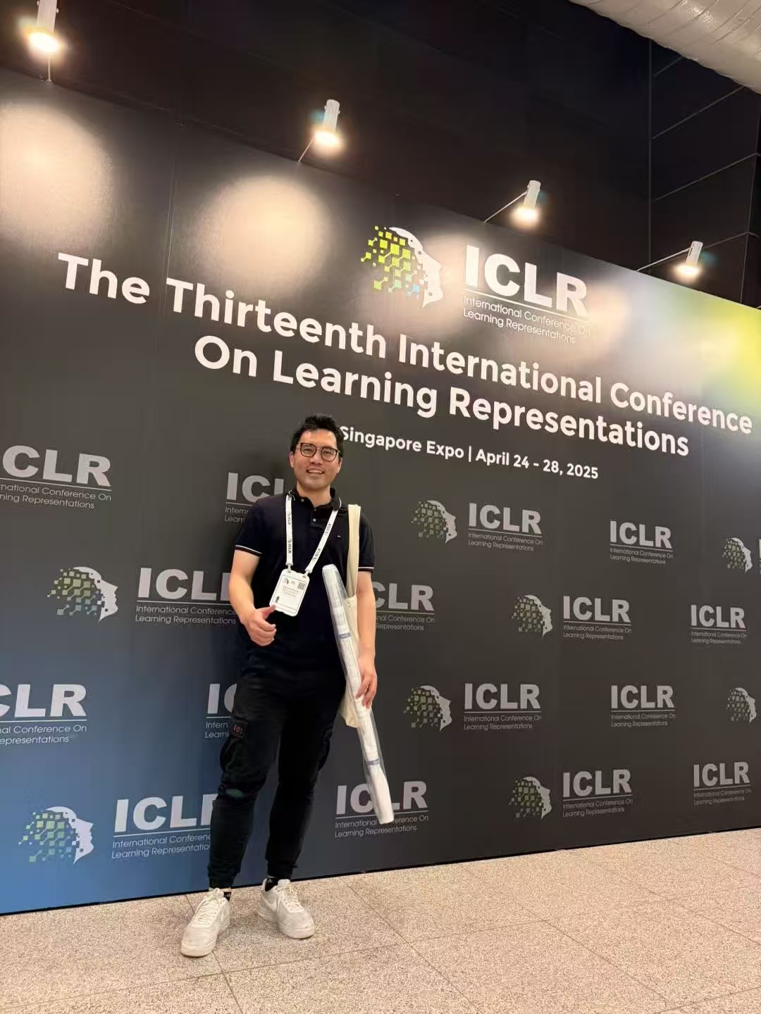 In front of the ICLR 2025 backdrop at Singapore Expo