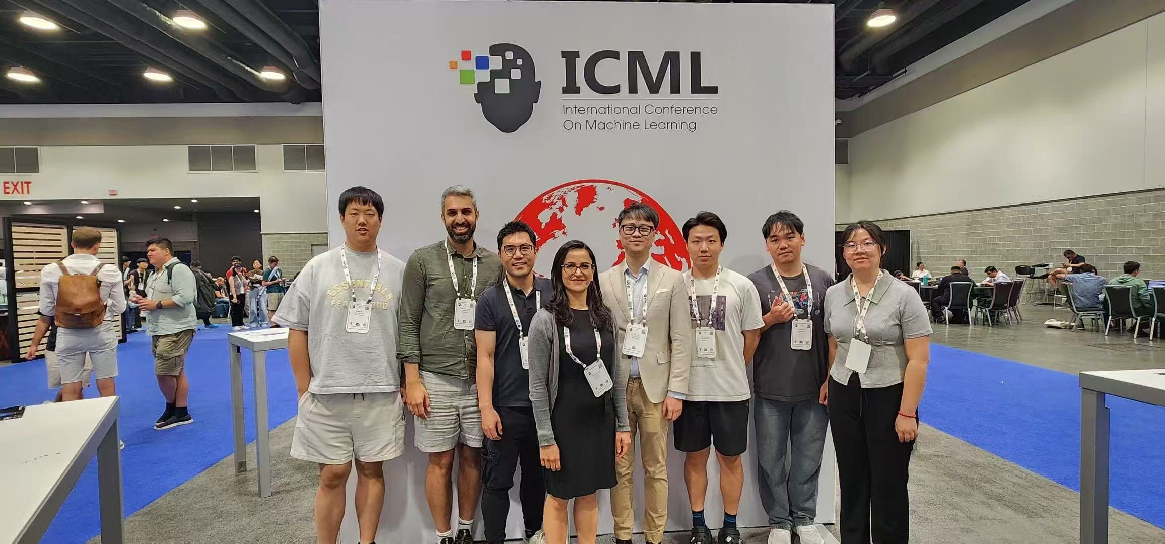 Group photo in front of the ICML backdrop