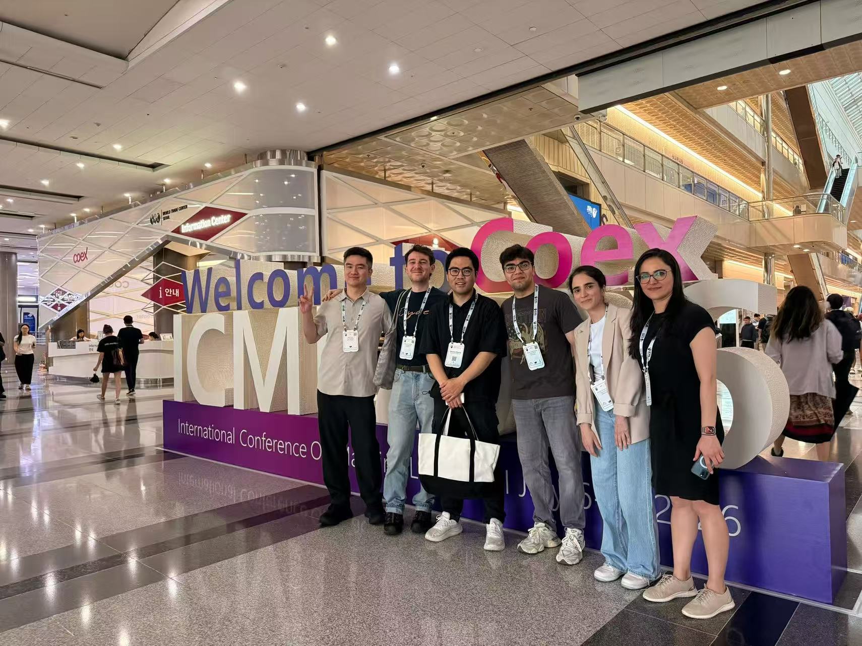Group photo at the ICML welcome sign in Coex