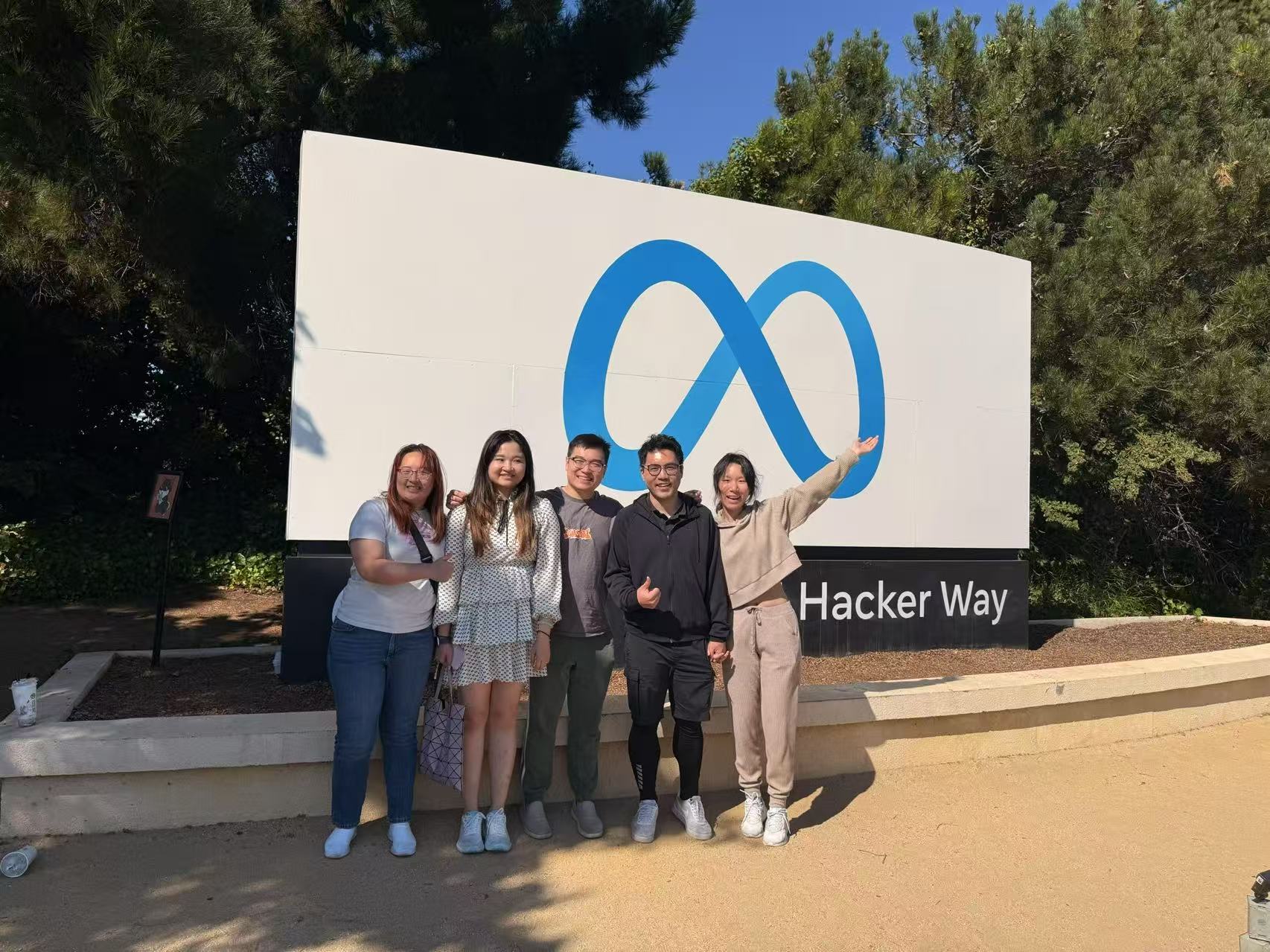 At the Meta sign on Hacker Way